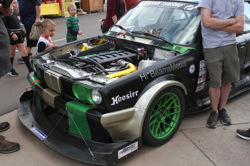A boy at Fan Fest stares at the big engine under the E30's hood.